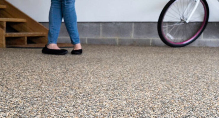 A woman and her bike on a stone and epoxy floor by Coastal Stone Flooring.