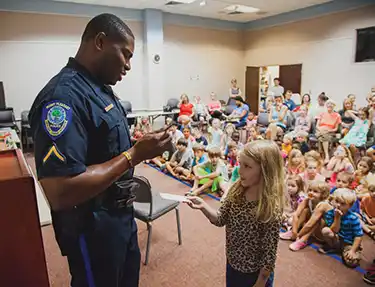 Officer Jermaine Gilliard of the Mount Pleasant Police Department engages with students.